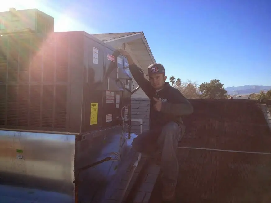 HVAC technician performing HVAC Inspection on a rooftop unit in Dallas